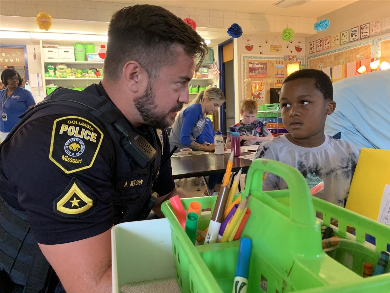 A Blue Ridge student shares his writing and illustration with a Columbia Police Officer.